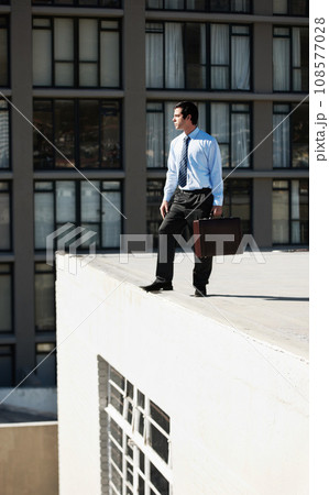 Businessman, suicide and roof with stress, depression and mental health with suitcase outdoor in city. Professional, person or employee on rooftop of building with anxiety, risk, crisis or suffering Businessman, suicide and roof with stress, depression and mental health with suitcase outdoor in city. Professional, person or employee on rooftop of building with anxiety, risk, crisis or suffering 108577028