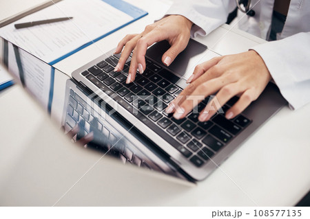 Female doctor, hand and typing on laptop in office for communication, consultation or treatment in closeup. Woman, nurse and technology for telehealth, medicine or insurance with results by internet 108577135