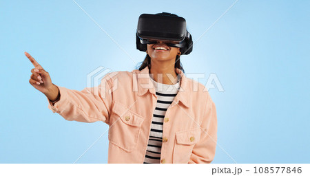 Virtual reality, press on screen and woman with future technology and smile in studio on blue background. Hologram, 3D and metaverse, digital world and high tech with user experience and VR software Virtual reality, press on screen and woman with future technology and smile in studio on blue background. Hologram, 3D and metaverse, digital world and high tech with user experience and VR software 108577846