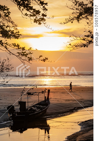 Silhouette shot of fishing boat on the beach during sunset 108578957