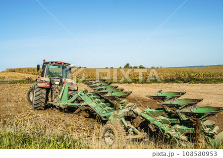 Tractor in the field. Agricultural machinery. Agricultural farm tractor during tillage of soil and field after harvest. Tractor in the field. Agricultural machinery. Agricultural farm tractor during tillage of soil and field after harvest. 108580953