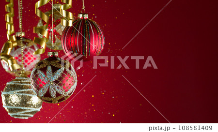 Decorative Christmas Balls with Bokeh Lights and Glitters Falling Decorative Christmas Balls with Bokeh Lights and Glitters Falling 108581409