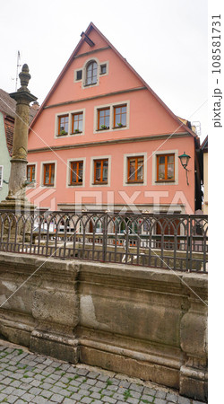 The fragment or detail of historical building at Rothenburg ob der Tauber where is the fortified city at Germany. The fragment or detail of historical building at Rothenburg ob der Tauber where is the fortified city at Germany. 108581731