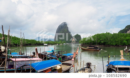 Cloudy morning at Fishing villages with long tail boat ,mangrove forest and island 108582690