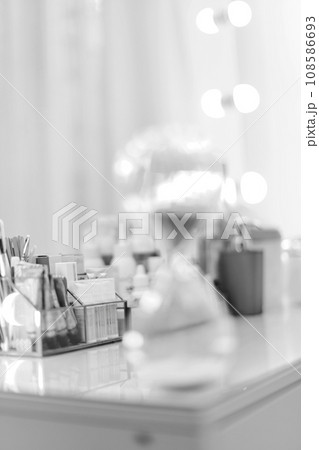 Table with decorative cosmetics in makeup room, black and white 108586693
