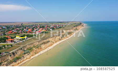 Panorama of sea shore in South Ukraine, Europe. Resort city with nice sand beach and clear blue sea. travel destination, ideal place for comfort vacation on black Sea. Drone photo Panorama of sea shore in South Ukraine, Europe. Resort city with nice sand beach and clear blue sea. travel destination, ideal place for comfort vacation on black Sea. Drone photo 108587525