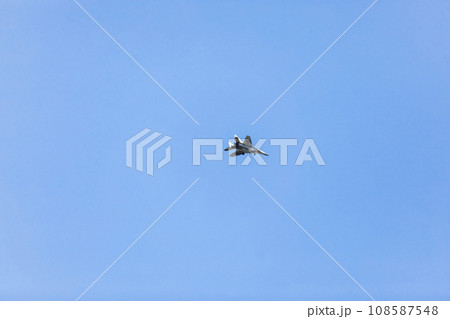 military white airplane flying in blue sky. selective focus. 108587548