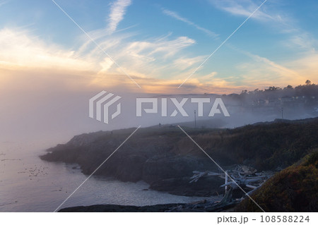 Scenic View of the Coastline on the West Pacific Ocean Coast. Foggy Sunset. Scenic View of the Coastline on the West Pacific Ocean Coast. Foggy Sunset. 108588224