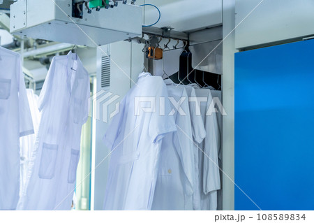Washed clothes are being conveyed to ironing machine Washed clothes are being conveyed to ironing machine 108589834