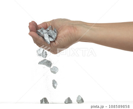 Silver ore nugget fall from industrial Miner hand fingers. Many pieces Silver nugget ore stone gravel found in hand of silver Mining industry. White background Isolated throwing freeze stop motion Silver ore nugget fall from industrial Miner hand fingers. Many pieces Silver nugget ore stone gravel found in hand of silver Mining industry. White background Isolated throwing freeze stop motion 108589858