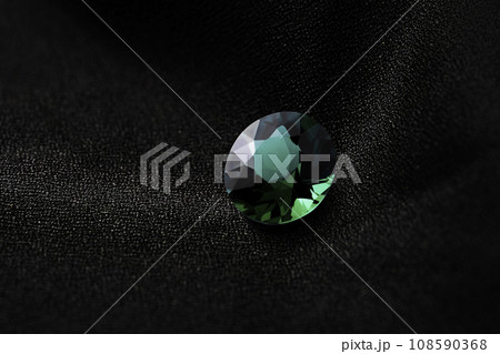 natural green emerald sapphire precious gemstone on black background natural green emerald sapphire precious gemstone on black background 108590368