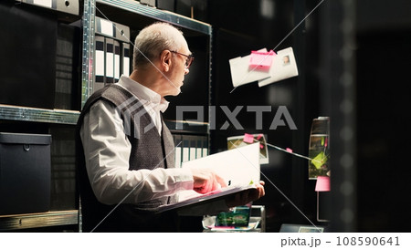 Police officers check forensic evidence to build strong case against the criminal, classified records. Criminologist and law enforcement agent searching for new investigation details. 108590641