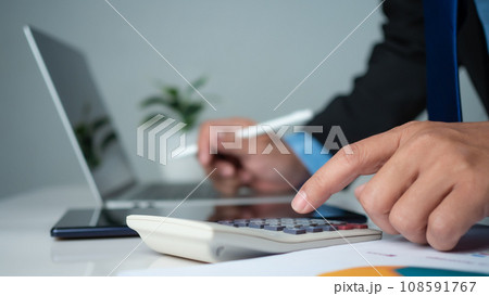 Business accounting concept. Business uses calculator with laptop computer, budget and income concept, sales concept, company accounting management. Business accounting concept. Business uses calculator with laptop computer, budget and income concept, sales concept, company accounting management. 108591767