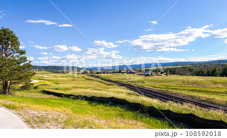 From the newly developed residential neighborhood in Colorado, a captivating view unfolds, showcasing vast farmland and a majestic mountain range in the distance, creating a picturesque and serene From the newly developed residential neighborhood in Colorado, a captivating view unfolds, showcasing vast farmland and a majestic mountain range in the distance, creating a picturesque and serene 108592018