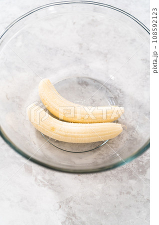 Mashing overhyped banana with a potato masher. 108592123