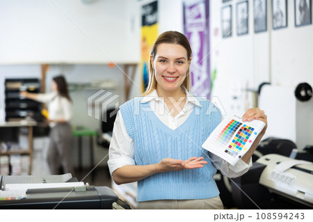 Portrait of a happy woman with color chart in her hand Portrait of a happy woman with color chart in her hand 108594243
