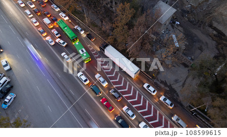 A crossroads with a lot of cars, buses and trucks A crossroads with a lot of cars, buses and trucks 108599615