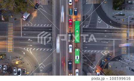 A crossroads with a lot of cars, buses and trucks 108599616
