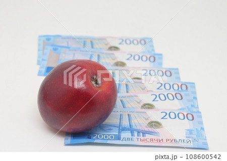 Red apple on banknotes. Rising food prices. World food crisis. Red apple on banknotes. Rising food prices. World food crisis. 108600542