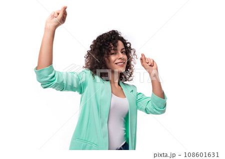 caucasian young leader woman with curly black hair dressed in an office blue jacket 108601631