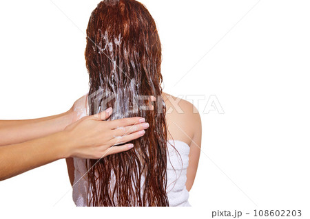 Back view. Female hands washing long hair with shampoo against white studio background. Vitamins and nutrition Back view. Female hands washing long hair with shampoo against white studio background. Vitamins and nutrition 108602203