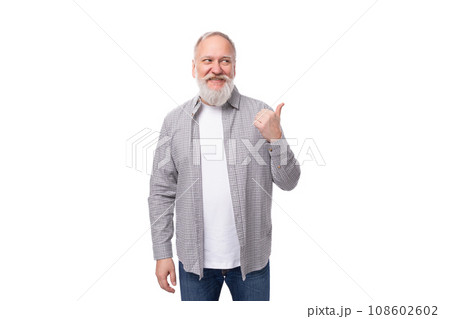 handsome retired man with a beard and a big mustache is dressed in a shirt and jeans handsome retired man with a beard and a big mustache is dressed in a shirt and jeans 108602602