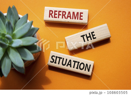 Reframe the situation symbol. Concept words Reframe the situation on wooden blocks. Beautiful orange background with succulent plant. Business concept. Copy space. 108603505