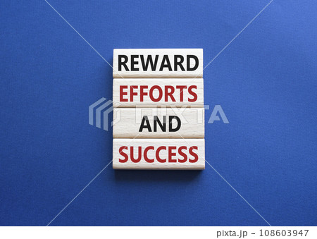 Reward Efforts and Success symbol. Concept words Reward Efforts and Success on wooden blocks. Beautiful deep blue background. Business concept. Copy space. 108603947