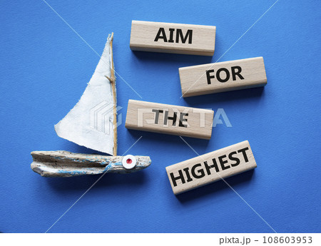 Aim for the Highest symbol. Concept words Aim for the Highest on wooden blocks. Beautiful blue background with boat. Business and Aim for the Highest concept. Copy space. Aim for the Highest symbol. Concept words Aim for the Highest on wooden blocks. Beautiful blue background with boat. Business and Aim for the Highest concept. Copy space. 108603953