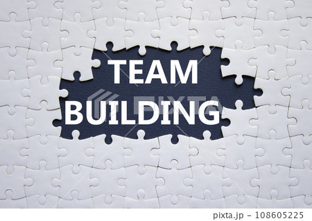 Team Building symbol. Concept word Team Building on white puzzle. Beautiful dark blue background. Business and Team Building concept. Copy space 108605225