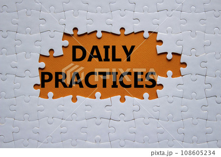 Daily Practices symbol. White puzzle with words Daily Practices. Beautiful orange background. Psychology and Daily Practices concept. Copy space. 108605234