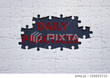 Daily Practices symbol. White puzzle with words Daily Practices. Beautiful dark blue background. Psychology and Daily Practices concept. Copy space. 108605510