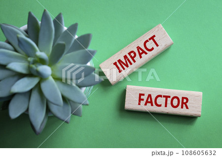 Impact Factor symbol. Wooden blocks with words Impact Factor. Beautiful green background with succulent plant. Business and Impact Factor concept. Copy space. 108605632