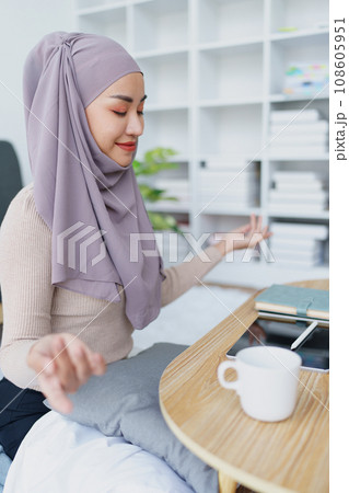 Muslim female employee Meditate while working in the office 108605951