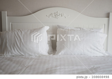white pillow lined up on bed  108608498