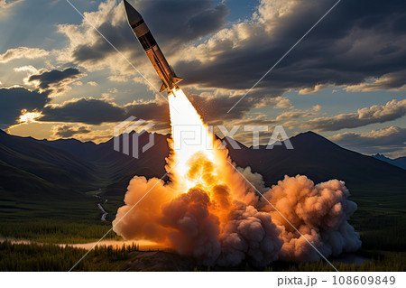 a rocket taking off from the ground with mountains in the background and clouds overhead over the photo is very dramatic 108609849