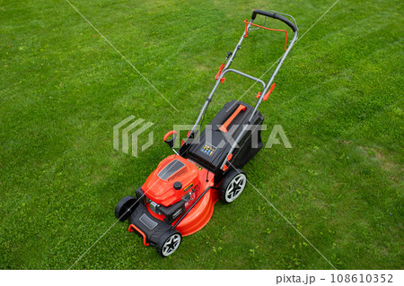 petrol self-propelled lawn mower on green grass petrol self-propelled lawn mower on green grass 108610352