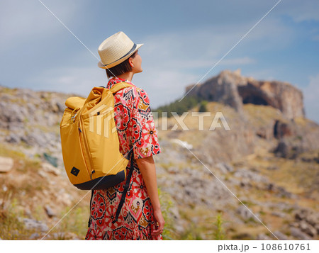 Nice Happy Female Enjoying Greek Islands. Travel to Greece, Mediterranean islands outside tourist season. Having fun at stunning view on sea resort and old town of Lindos on mountain 108610761