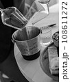 pouring wineglasses in spittoon at wine tasting black and white 108611272