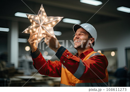 a man that is holding a star in one hand and smiling at the other while he holds it with both hands a man that is holding a star in one hand and smiling at the other while he holds it with both hands 108611273