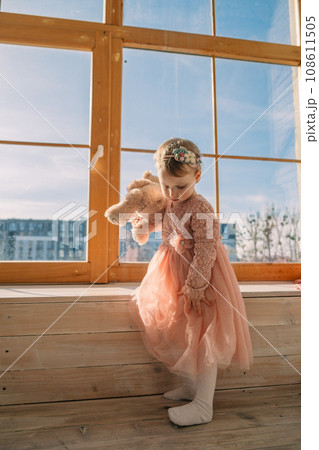 little cute girl in dress near window little cute girl in dress near window 108611505