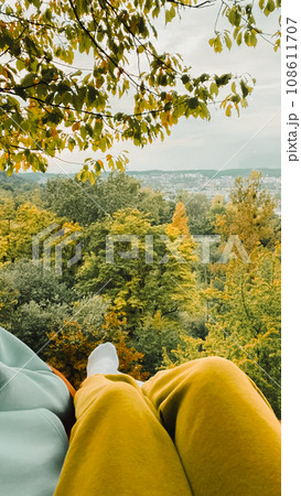 pov woman sitting on hammock looking at autumn forest pov woman sitting on hammock looking at autumn forest 108611707