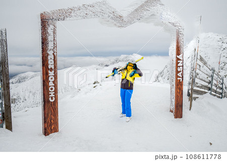 Slovakia, Jasna - January 31, 2022: woman skier on the top of the chopok mountain Slovakia, Jasna - January 31, 2022: woman skier on the top of the chopok mountain 108611778
