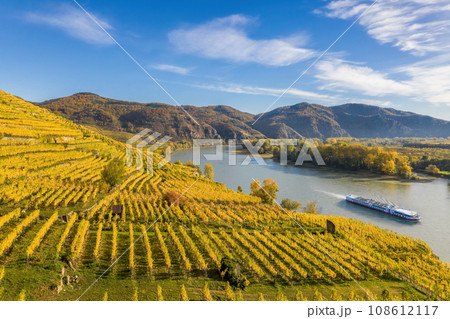 Autumn panorama of Wachau valley (Unesco world heritage site) with ship on Danube river near the Weissenkirchen village in Lower Austria, Austria 108612117