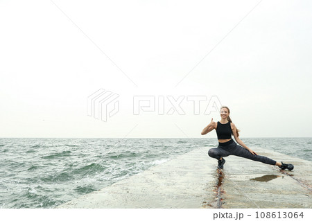 Woman in leggings at sea, space for text 108613064
