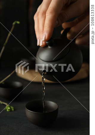 The concept of Asian tea, on a dark background with plants. 108613338