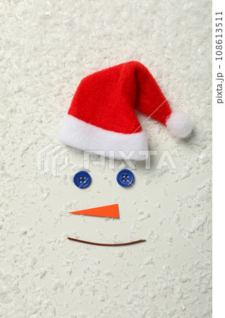 Snowman face with paper carrot and buttons Snowman face with paper carrot and buttons 108613511
