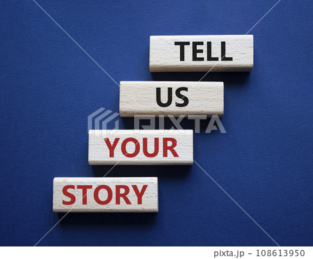 Tell us your story symbol. Concept words Tell us your story on wooden blocks. Beautiful deep blue background. Business and Tell us your story concept. Copy space. 108613950