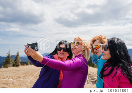 Group of women make self portraits during a mountain hike on top Group of women make self portraits during a mountain hike on top 108615895