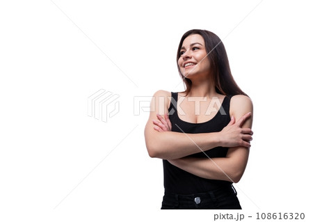 Casual pretty young brunette woman wearing a black t-shirt on a white background Casual pretty young brunette woman wearing a black t-shirt on a white background 108616320